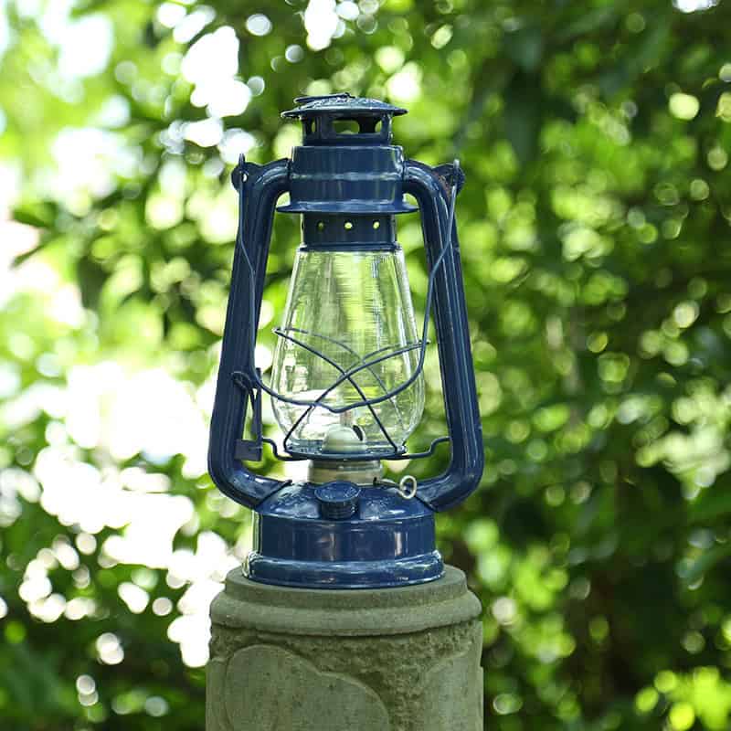 Vintage blue lantern for outdoor camping, hiking, or emergency use - ideal for adventurers and outdoor enthusiasts. Perfect for illuminating campsites and rural settings.