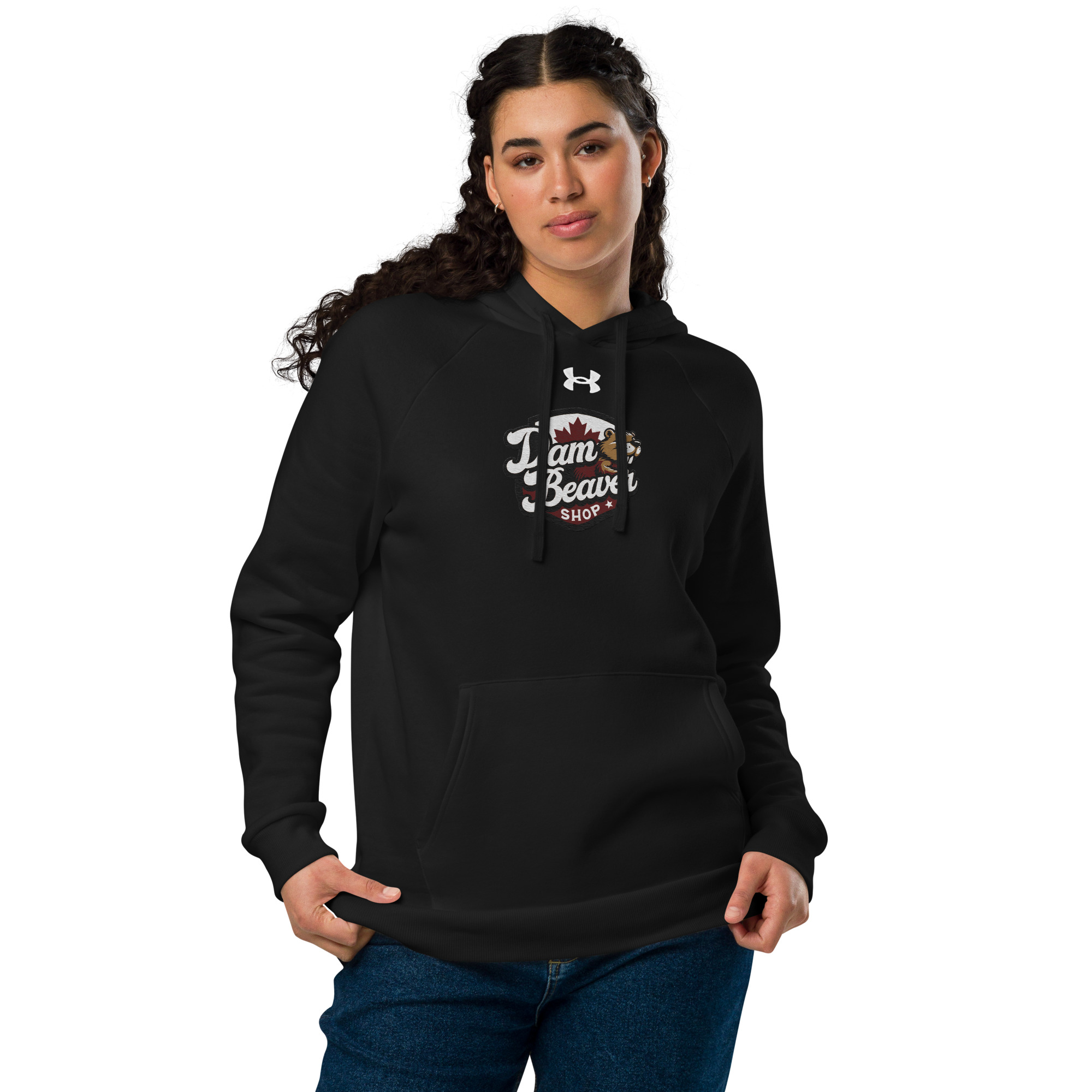A woman with long curly hair wears the Ultra-Soft Fleece Hoodie for All-Day Comfort and Style, featuring Damn Beaver Shop and a small beaver graphic on the front. She stands against a white background with her hands in the hoodie pockets.